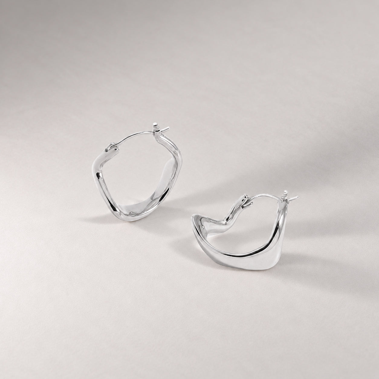 Curved Mini Hoop Earrings in Silver
