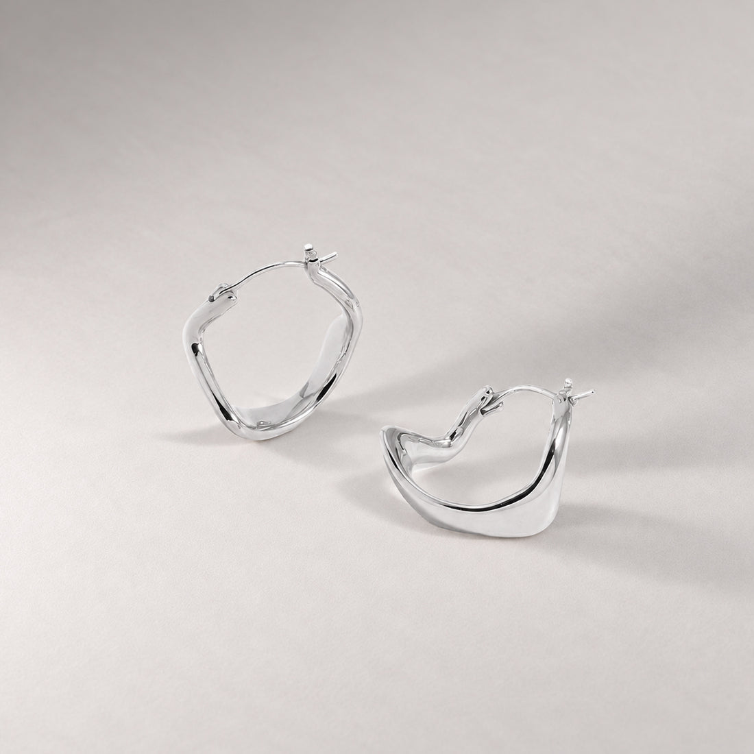 Curved Mini Hoop Earrings in Silver