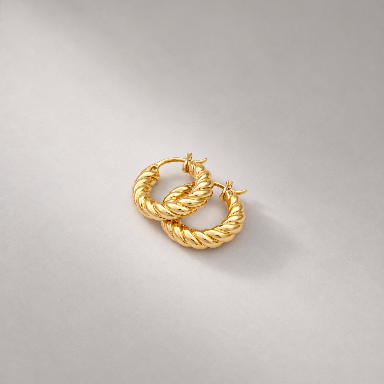 Fenny Twisted Mini Hoop Earrings in Gold