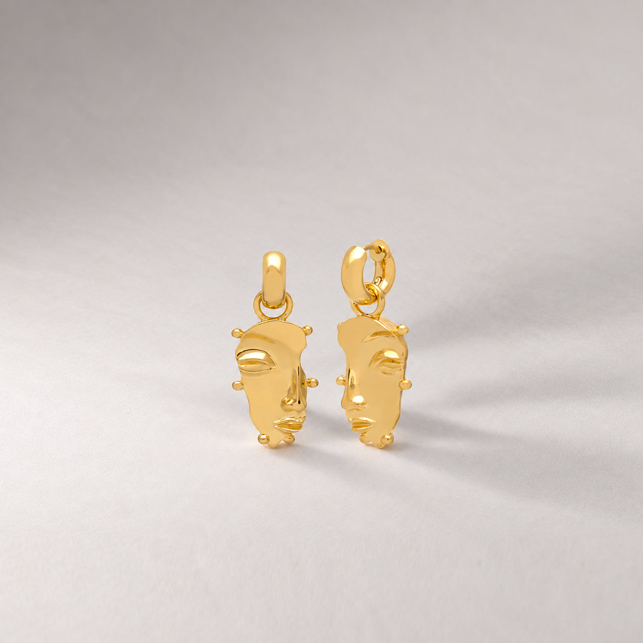 Visage Drop Hoop Earrings in Gold
