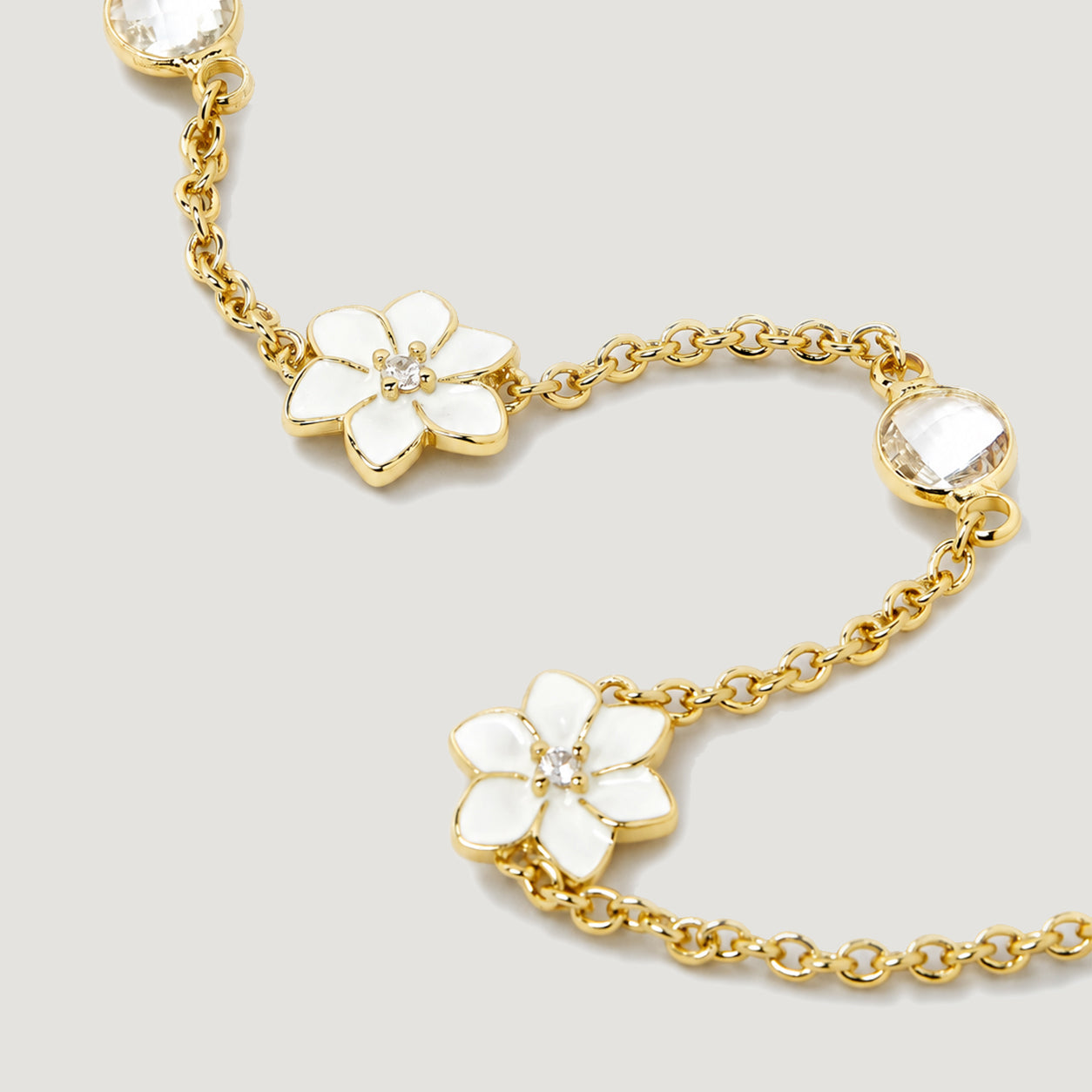 XANTIA FLOWER STONE STATION BRACELET IN GOLD & MOONSTONE WITH WHTE ENAMEL