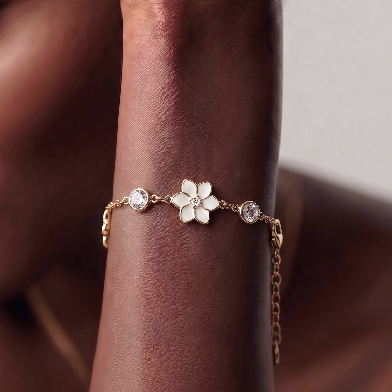 XANTIA FLOWER STONE STATION BRACELET IN GOLD & MOONSTONE WITH WHTE ENAMEL
