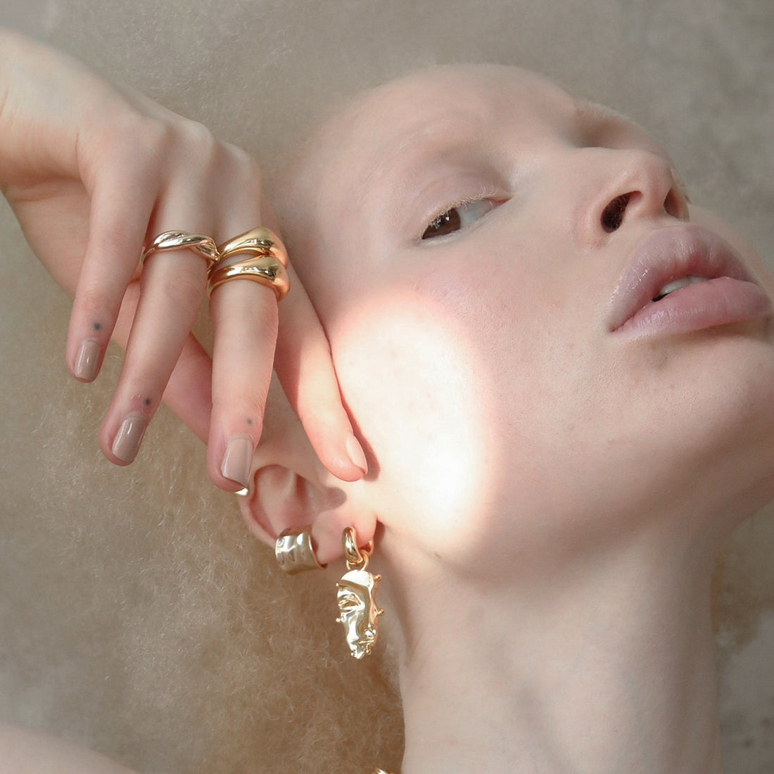 Visage Drop Hoop Earrings in Gold